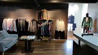Actual garment racks and menswear selection inside Club Man Shop